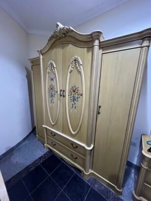 two beds and a closet with a mirror stan...