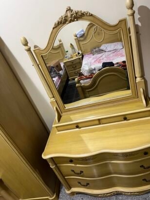 two beds and a closet with a mirror stand